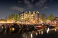 A bridge over the canal in Amsterdam at night.
