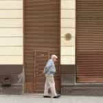A man walks past a closed storefront in Valparaíso, Chile.