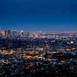 The city skyline of Los Angeles illuminated at night.