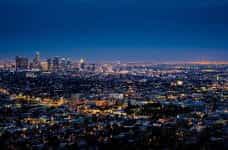 The city skyline of Los Angeles illuminated at night.