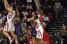 NBA Basketball player Yao Ming throws basketball in hoop.