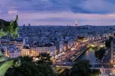 A gargoyle in Paris. The Eiffel tower is in the background.