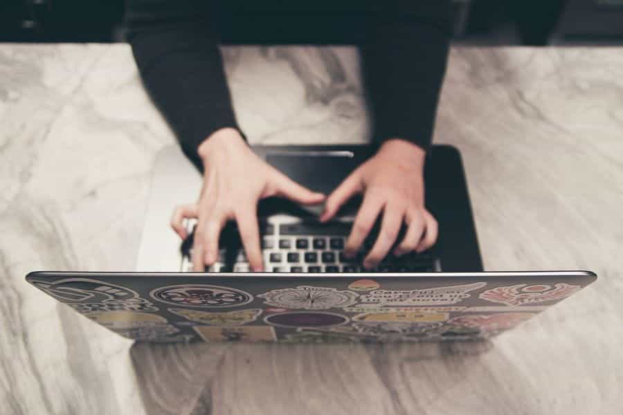 Person playing online slots on a laptop.