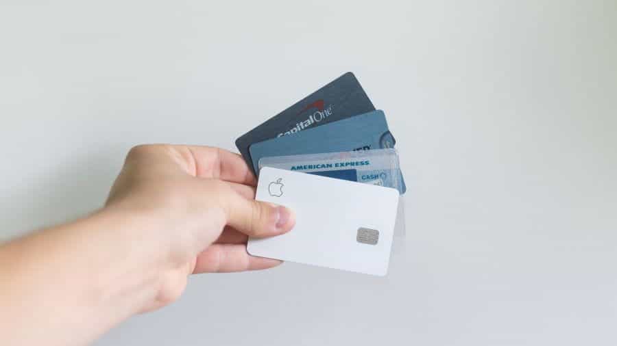 Hand holding out a selection of credit and debit cards.
