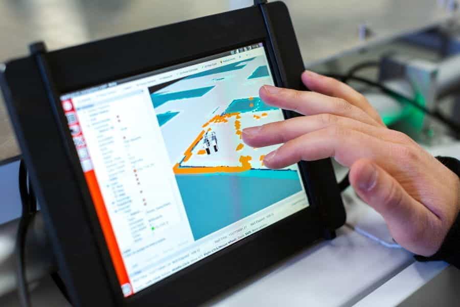 A graphic designer uses an iPad to design a digital blueprint.