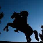 A silhouette of a monument featuring a man riding a horse in Mexico.