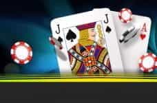 A Jack of Spades and an Ace of Hearts with casino chips.