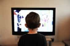 A small child watching television.