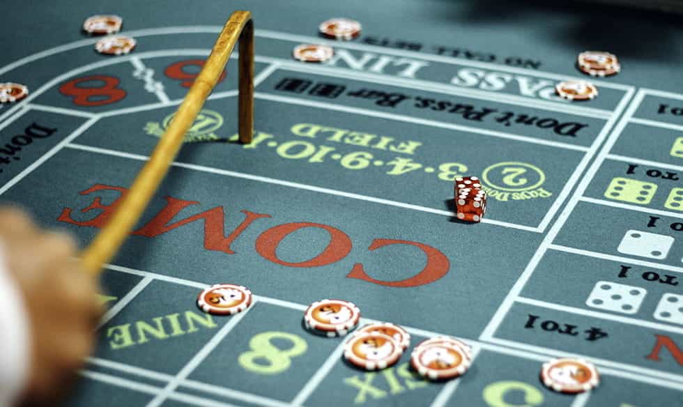 A craps table with dice and casino chips.