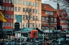 A row of bikes in front of houses in Copenhagen, Denmark.