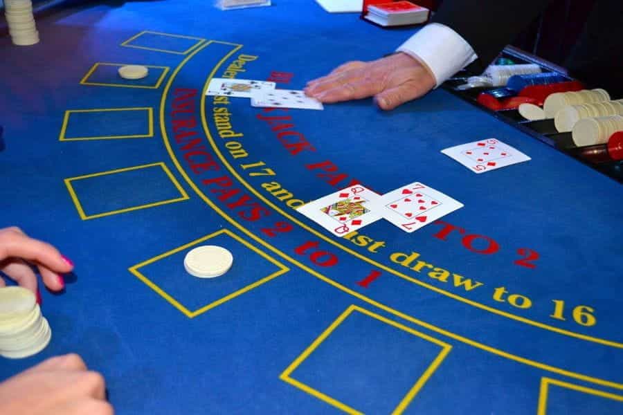 A casino croupier deals blackjack cards.