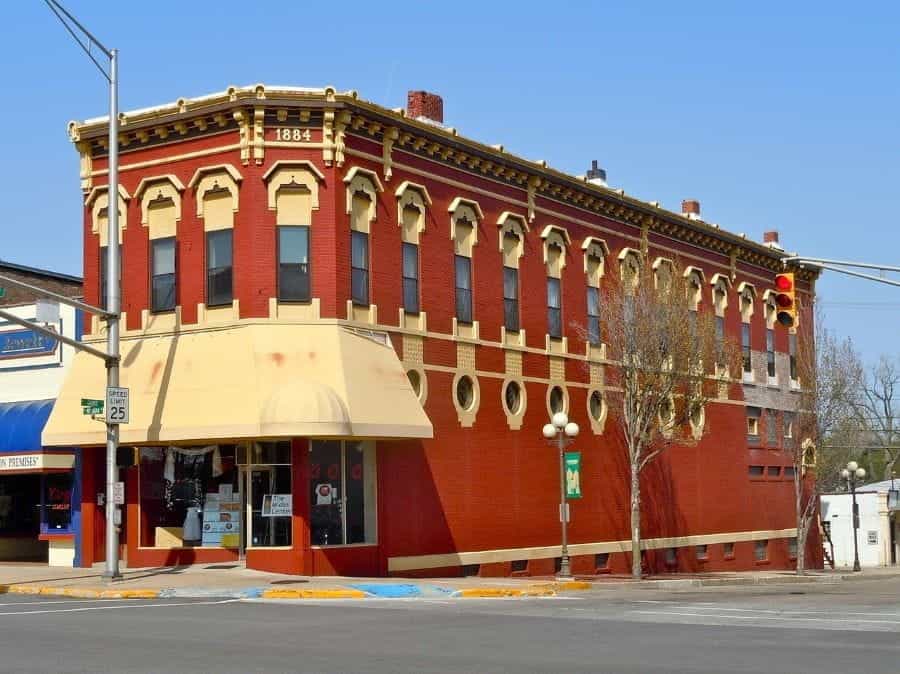 A red brick building on a street corner in Plymouth, Indiana.