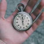 A stopwatch being held in a person's hand.