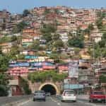 A roadway runs through a mountain of houses in Caracas, Venezuela.