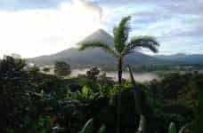 A volcano erupts over the jungle in Costa Rica.