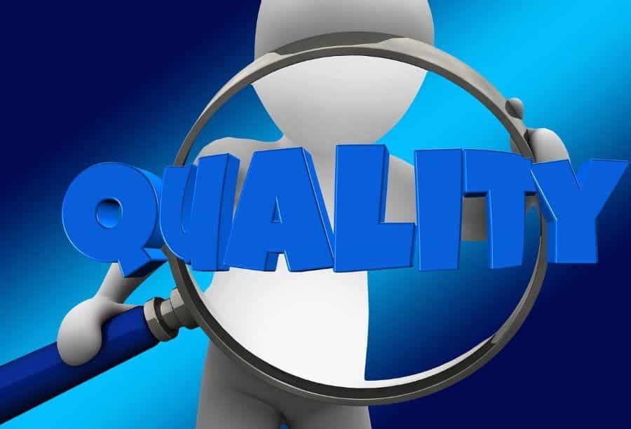 A white cartoon figure holds up a magnifying glass over the word QUALITY.