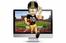 US football player runs straight out of the computer screen, which shows a football game.