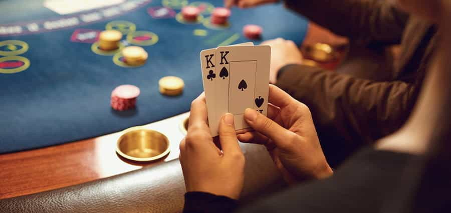 A woman holding two playing cards.