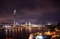 A brightly lit up tower in Macau at night time.