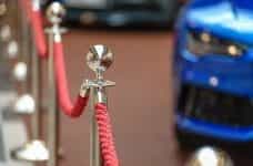 A red rope as would be found around a VIP area or a red carpet.