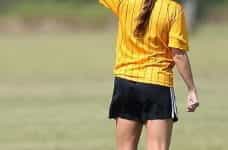 A referee in giving a yellow card in a football match.