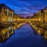 A canal in Amsterdam at night time.