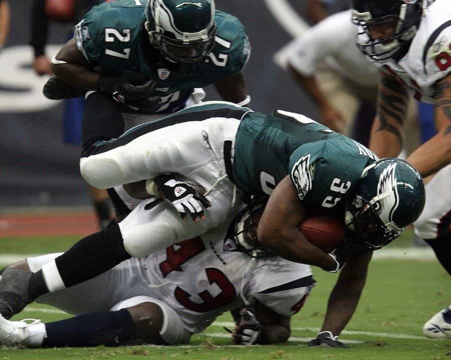A player from the Philadelphia Eagles tackles an opposing player.