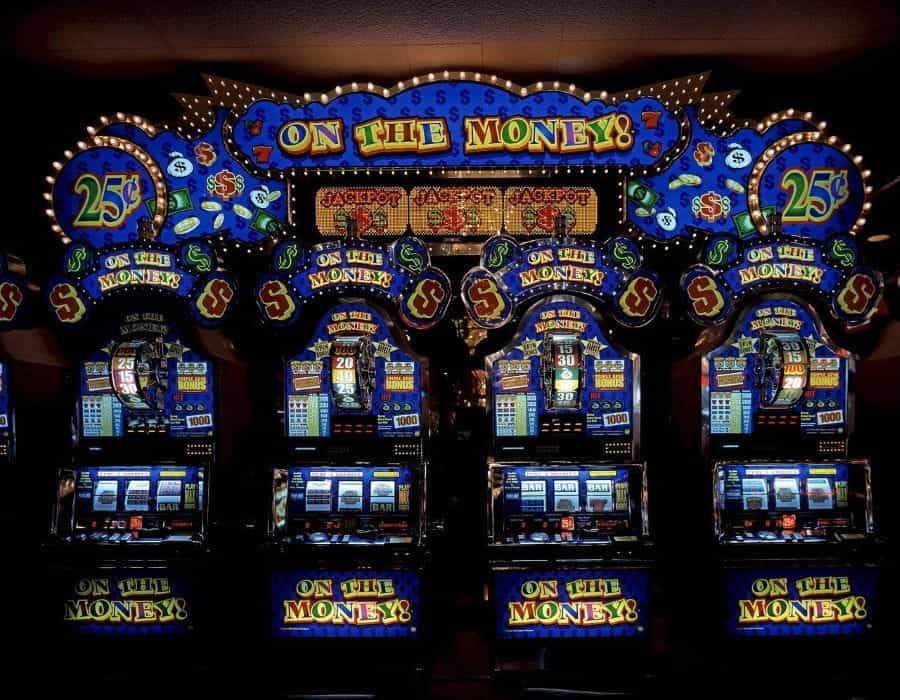 A row of four slot machines in a casino.