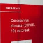 A red emergency sign warning of coronavirus outbreak.