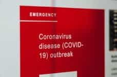 A red emergency sign warning of coronavirus outbreak.