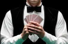 A man holding five playing cards.
