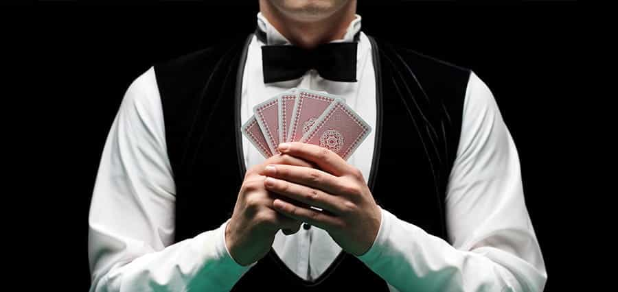 A man holding five playing cards.