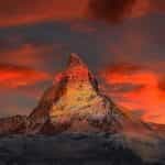 The famous Swiss Matterhorn mountain surrounded by red skies.