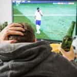 Football fan watching TV.