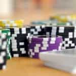 Colorful poker chips and a stack of playing cards.