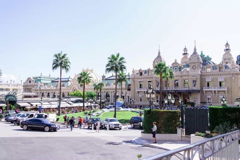 The Monte Carlo Casino in Monte Carlo, with a large procession of guests and tourists gathered in front.