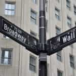 Street signs at the intersection of Broadway and Wall Street in New York City, New York.