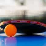 Table tennis paddle and ball.