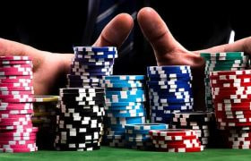 Someone pushing poker chips across a table.