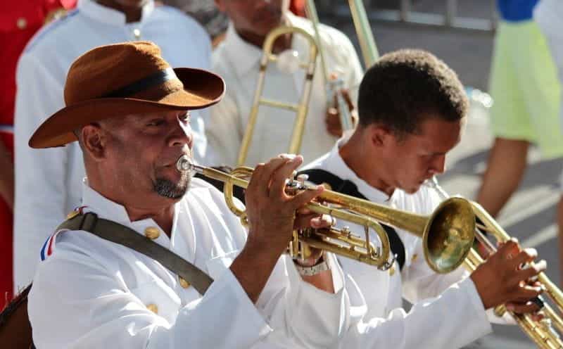 Two men play trumpets at a parade in the Dominican Republic.