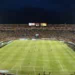 A crowded soccer stadium at night.