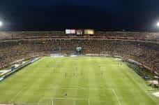 A crowded soccer stadium at night.