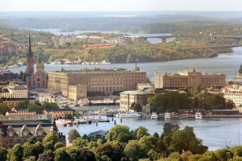 An aerial view of the Swedish capital city of Stockholm’s Royal Palace, with water and bridges surrounding it.