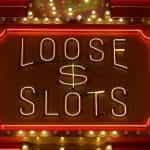 A lit-up neon casino sign, reading LOOSE $ SLOTS.