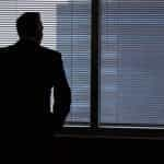 Businessman standing in board room.