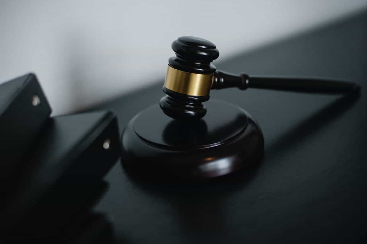 A wooden judge's gavel on an office desk.