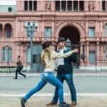 A man and woman tango in front of Argentina’s Casa Rosada.