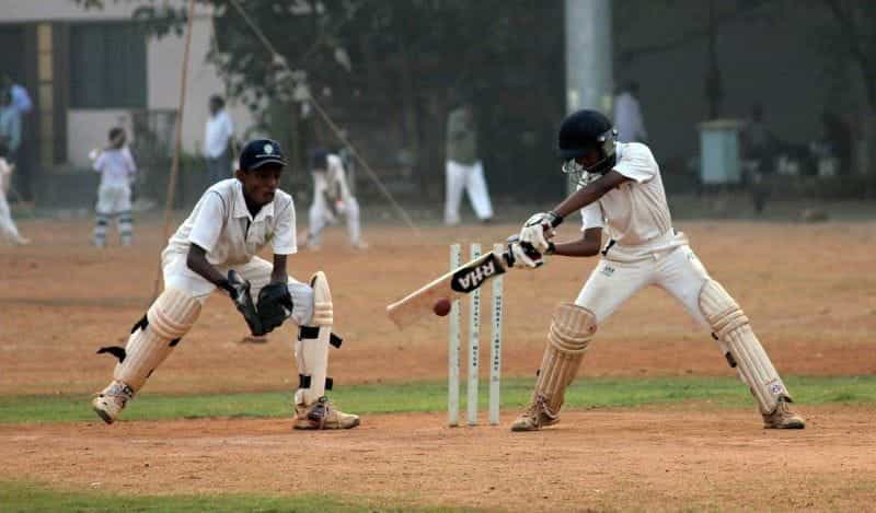 Indian cricketers playing.