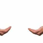 Two empty, outstretched hands facing one another on a white background.