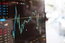 A black computer screen with a financial graph.